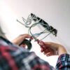 Unrecognizable electrician working on the electrical installation of a house Some Product